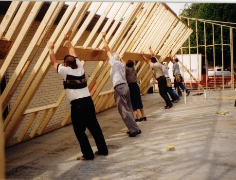 People raising a structural wall