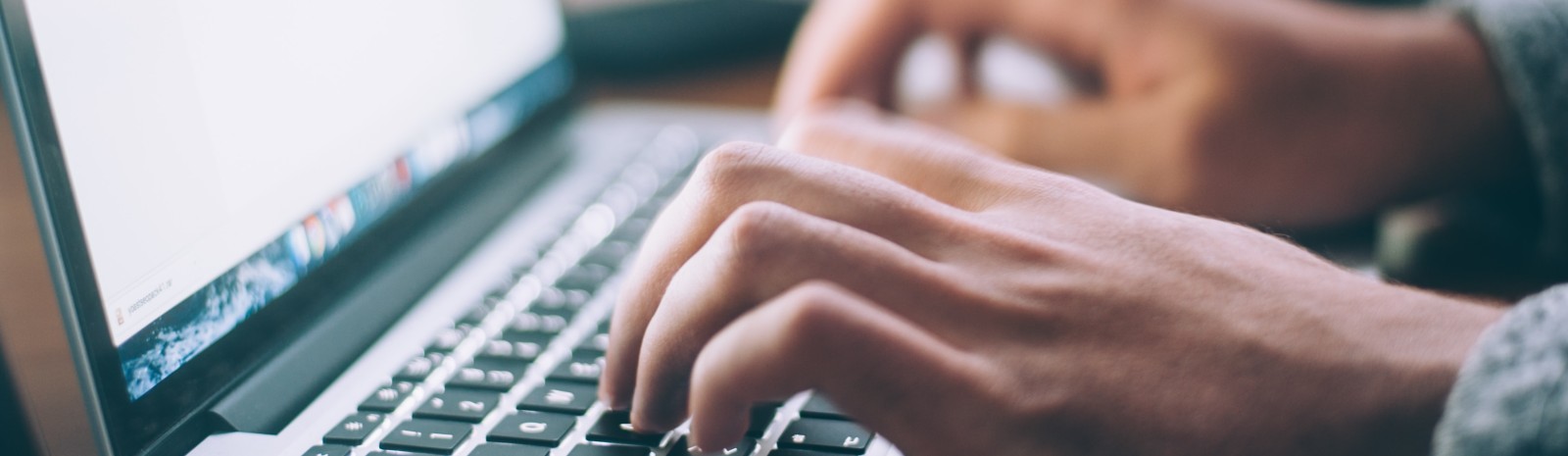 hands typing at a keyboard