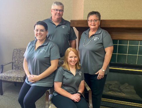 Picture of employees by a fireplace