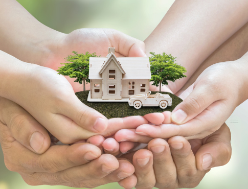 Hands holding a home with car parked outside